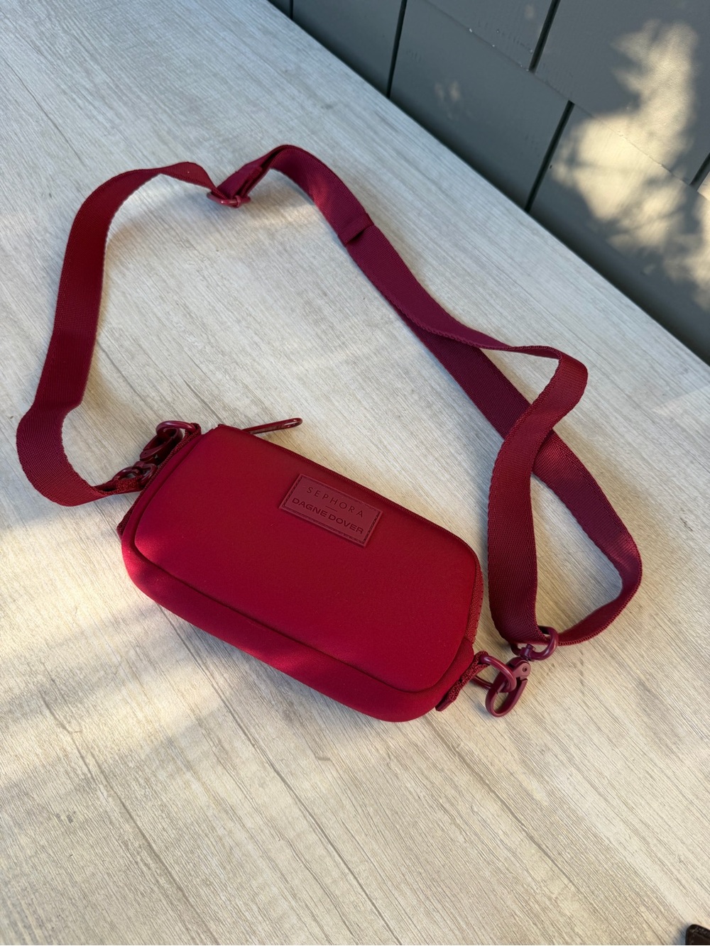 Limited-edition Dagne Dover x Sephora Mara Phone Sling in a vibrant spice-red